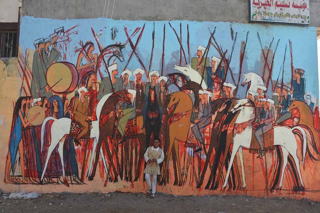 Artist Alaa Awad paints a mural.